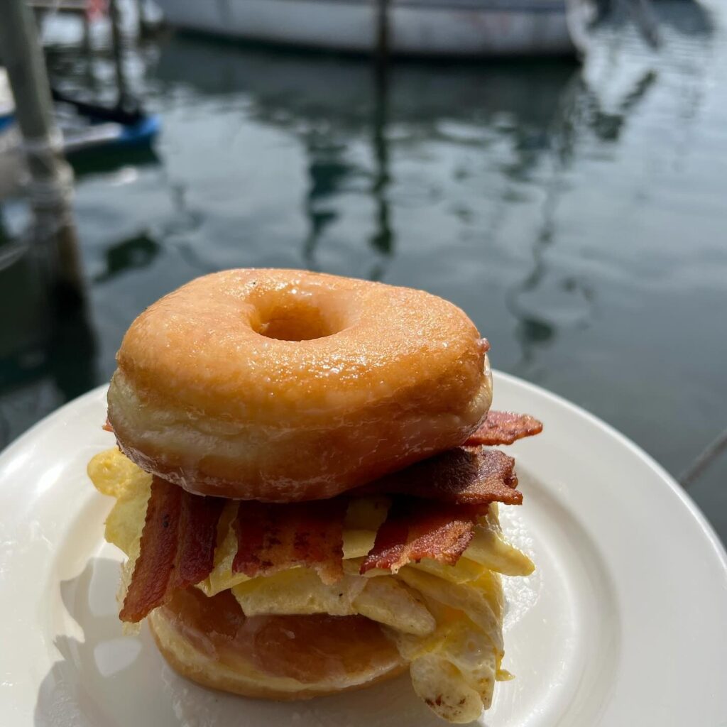 Bayou Joe's On Massalina Bayou breakfast option, donut sandwich with bacon | waterfront restaurant in Panama City, Florida offering breakfast, lunch & dinner with a view